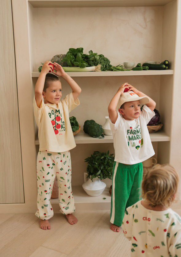 Three young children in matching 'Farmers Market' printed pajama sets